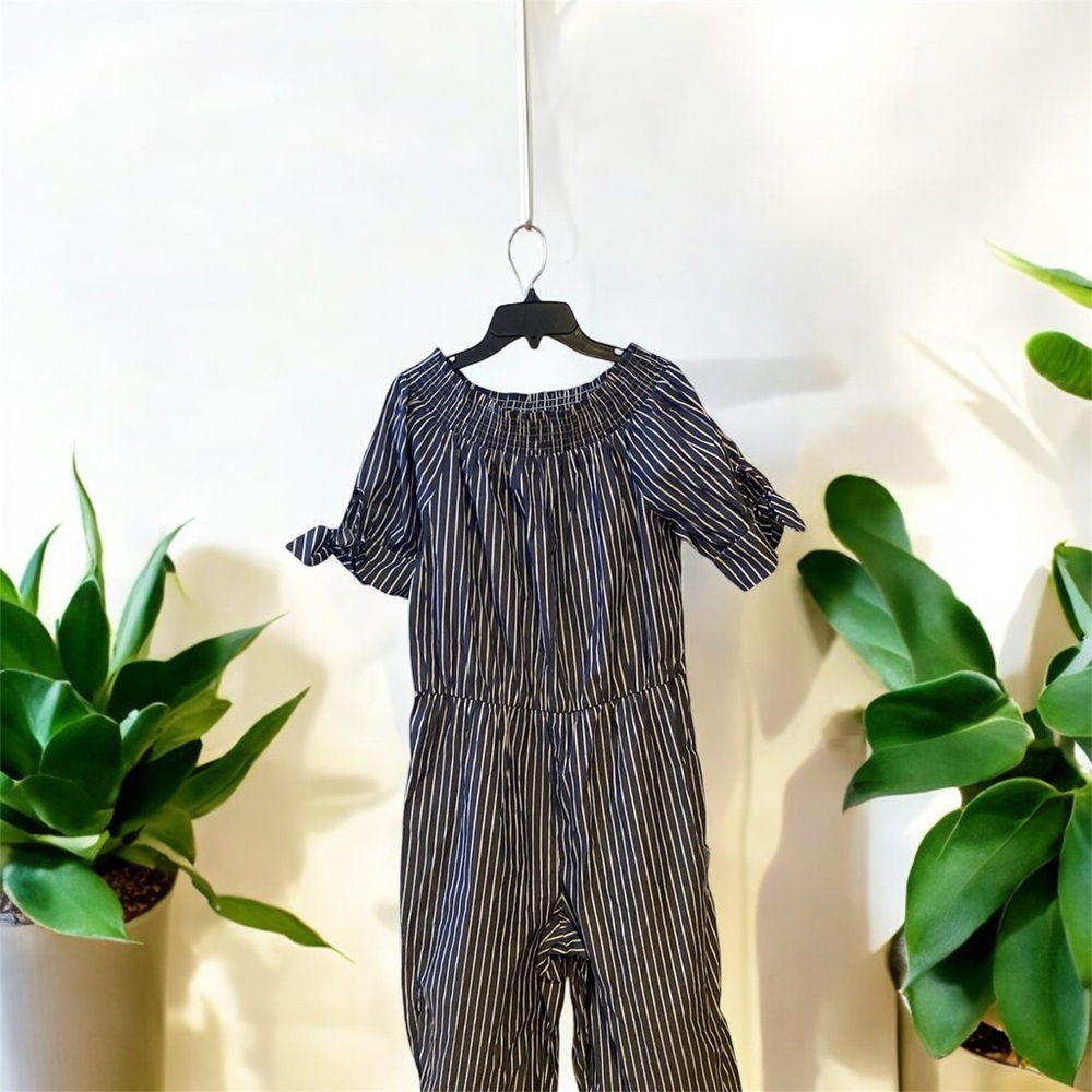 Gray with white jumpsuit has been used it’s in good condition